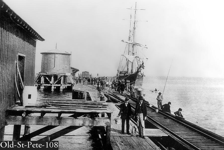 2 men leaving the The St Pete Pier  after catching fish late 1890s